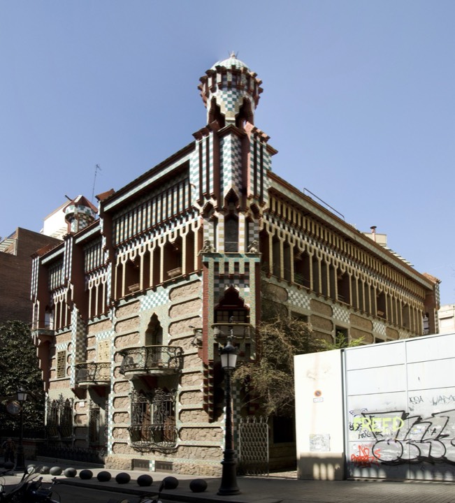 Façade of Casa Vicens in Barcelona, showing its bands of bare brick, green-and-white marigold tiles and corner turrets