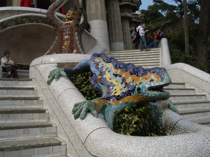 Close-up of the trencadís mosaic dragon on the staircase at Park Güell, its skin made of coloured broken ceramic fragments